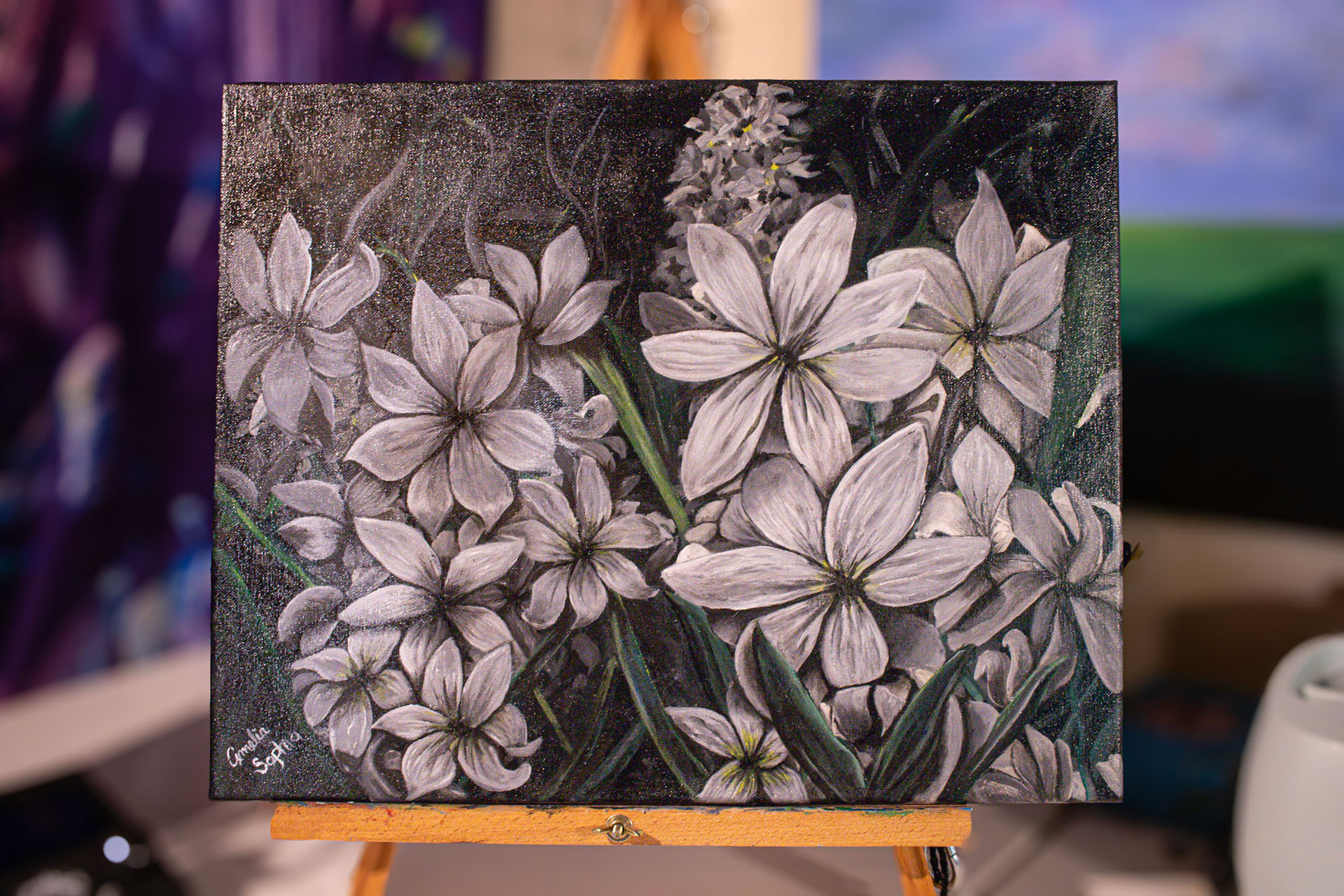 Acrylic painting of black and white flowers on a black canvas. Acrylic painting of black and white flowers on a black canvas.